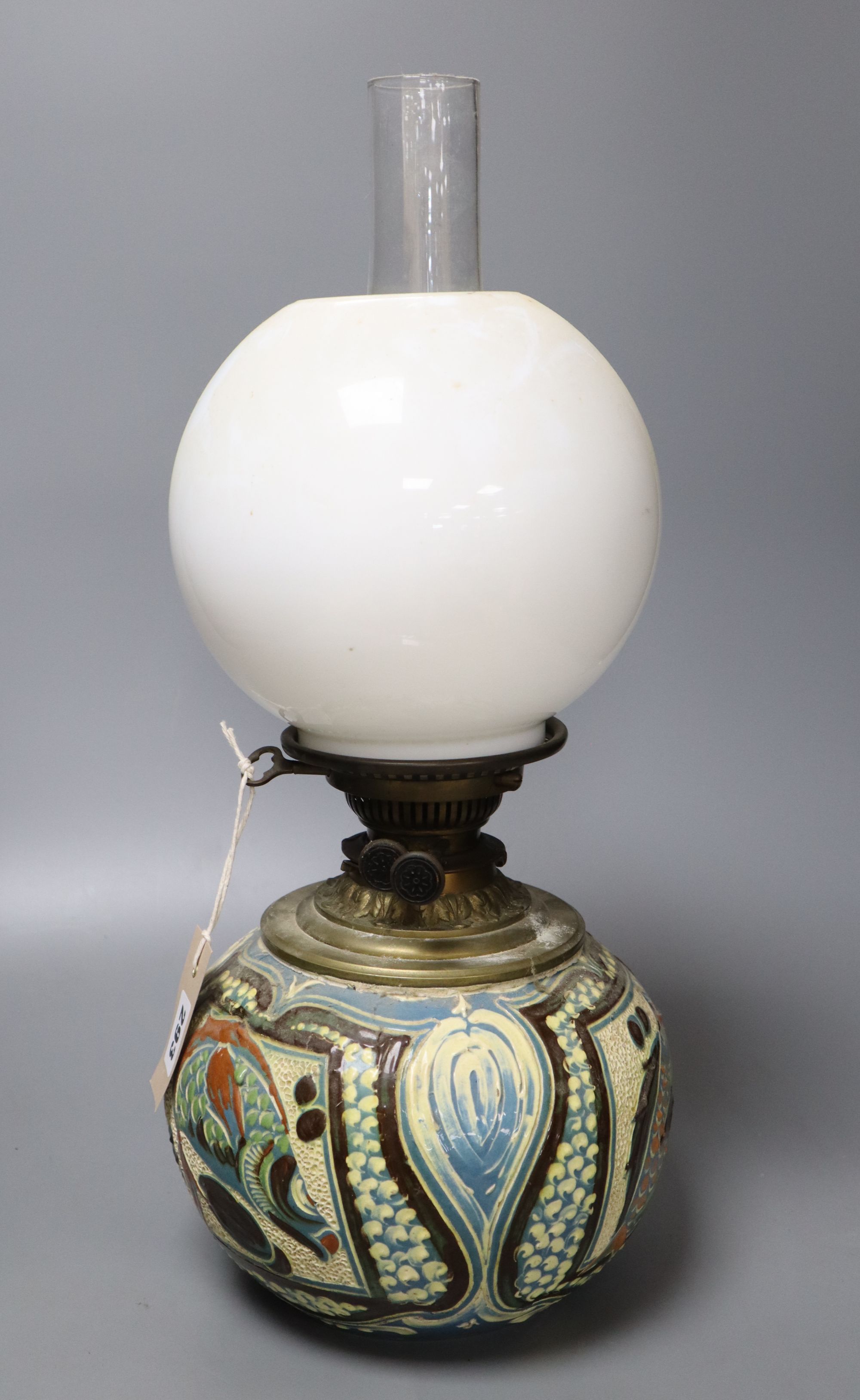 A C. H. Brannam Barum pottery oil lamp, decorated with fish, signed and dated 1899, height 50cm including chimney